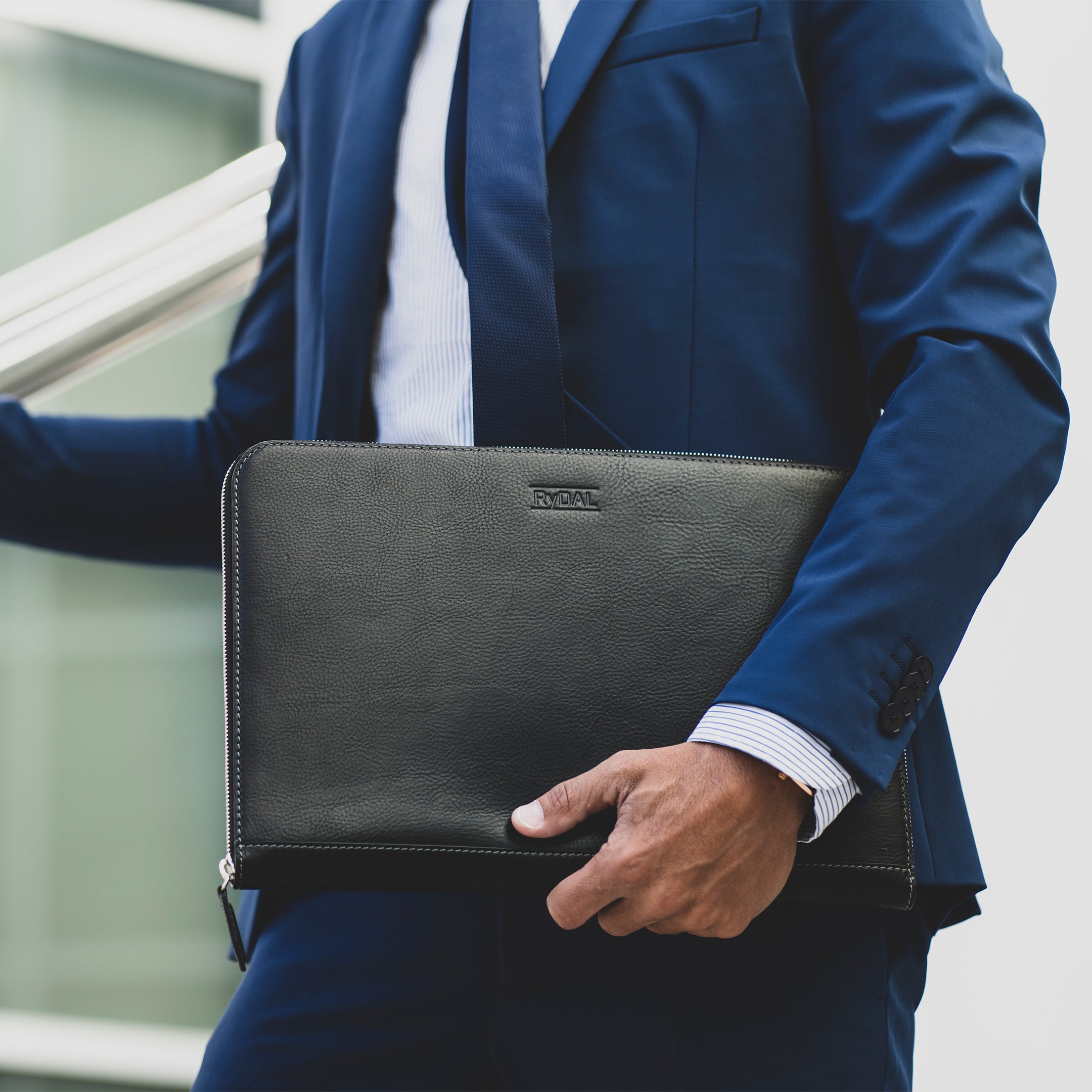 Model carrying Albany Leather Document Holder from Rydal in 'Black'.