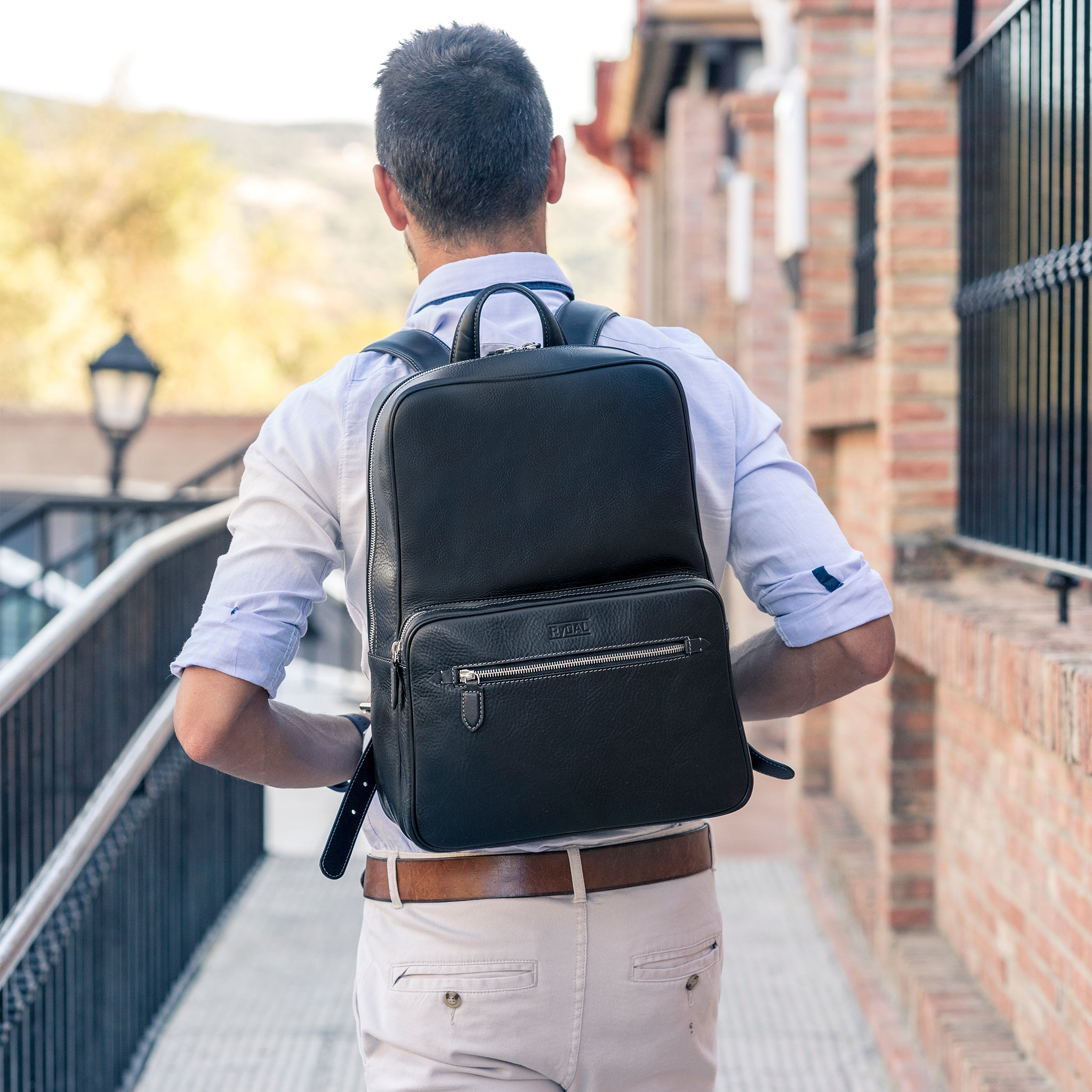 Model wearing the Henley Mens Leather Backpack from Rydal in 'Black'.