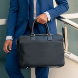 Model carrying Lexington Mens Leather Briefcase from Rydal in 'Black'.