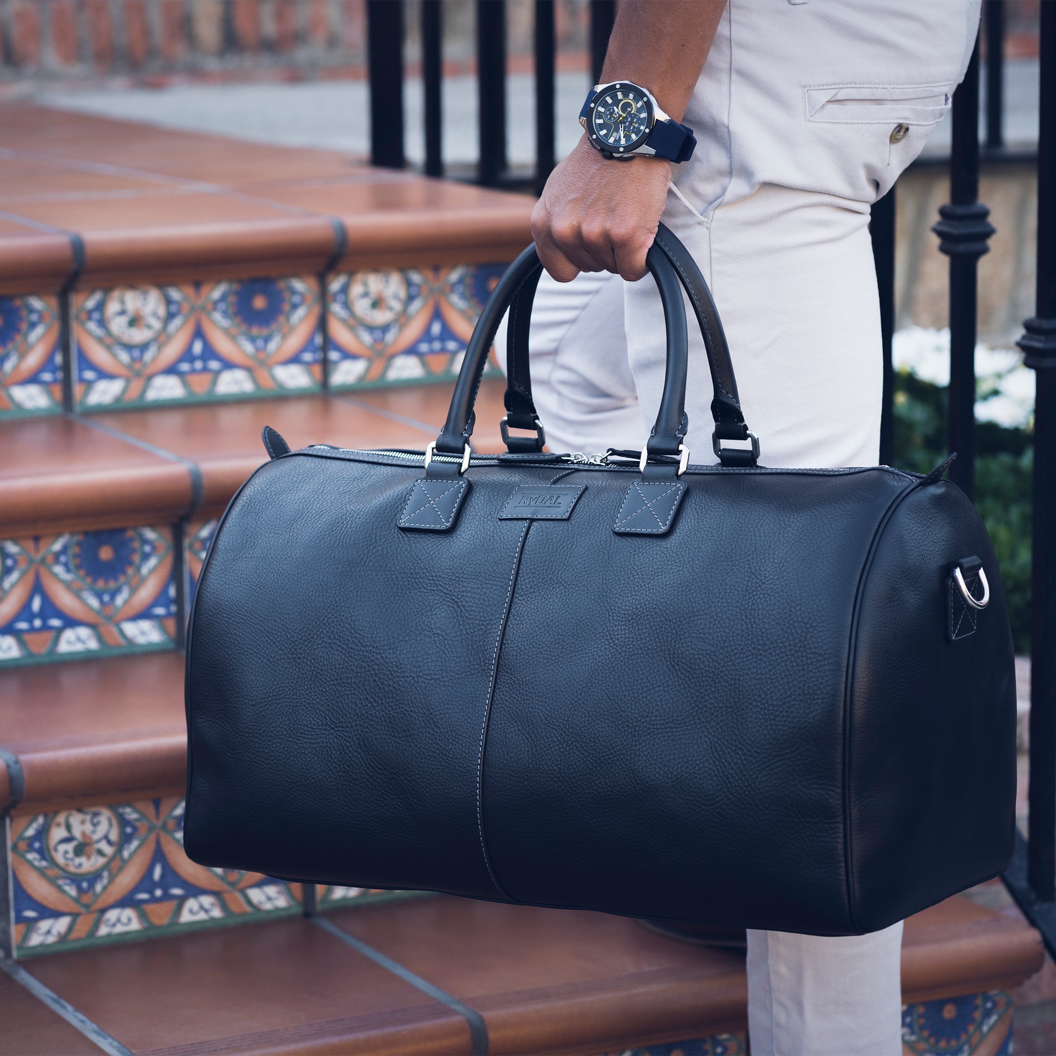 Model using the Portland Mens Leather Travel Bag from Rydal in 'Black'.