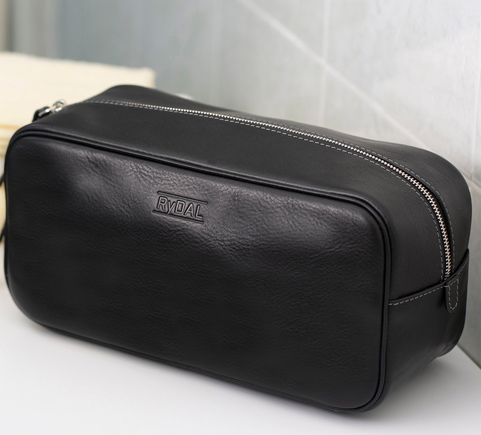 Mens Leather Wash Bag from Rydal in 'Black' in use.