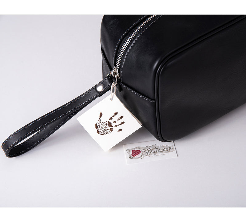 Mens Leather Wash Bag from Rydal in 'Black' showing Guarantee Labels.
