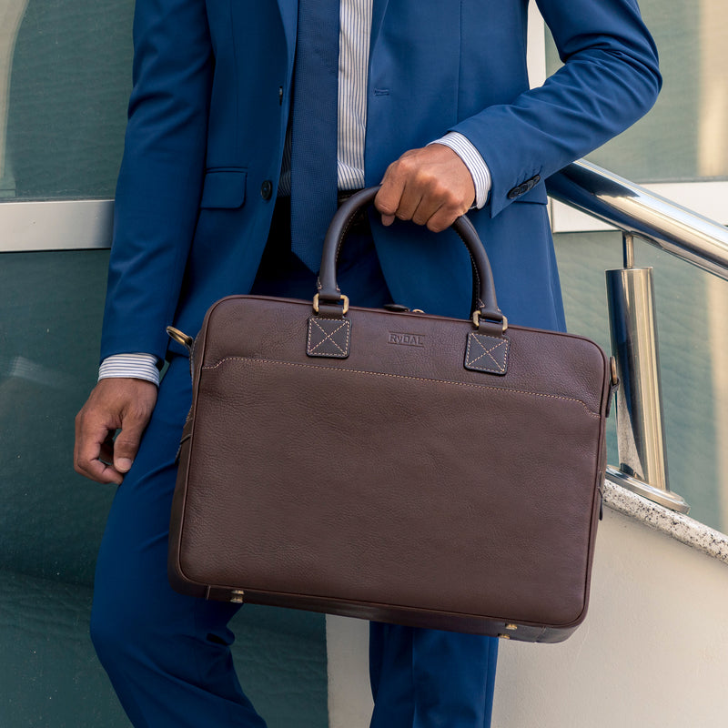Model carrying Lexington Mens Leather Briefcase from Rydal in 'Dark Brown'.