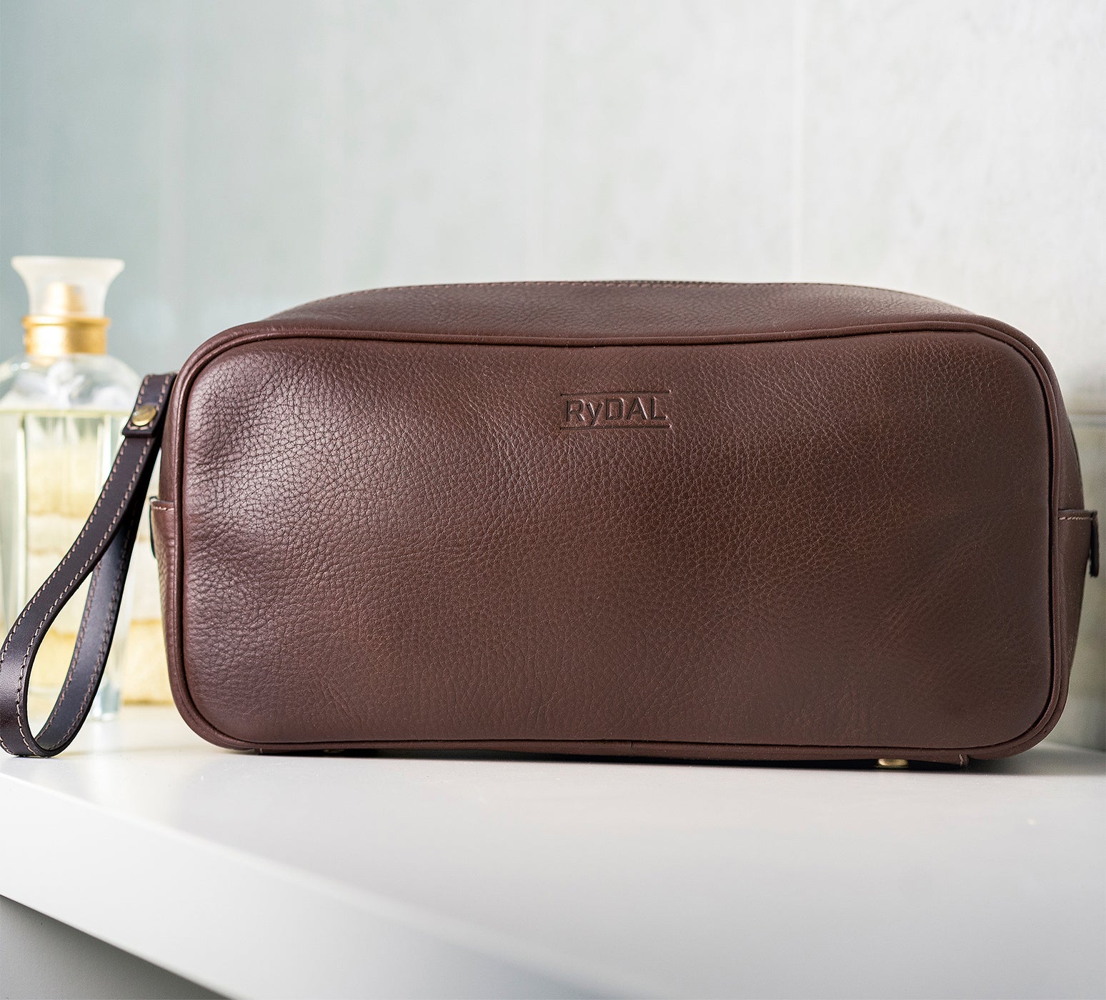 Mens Leather Wash Bag from Rydal in 'Dark Brown' in use.