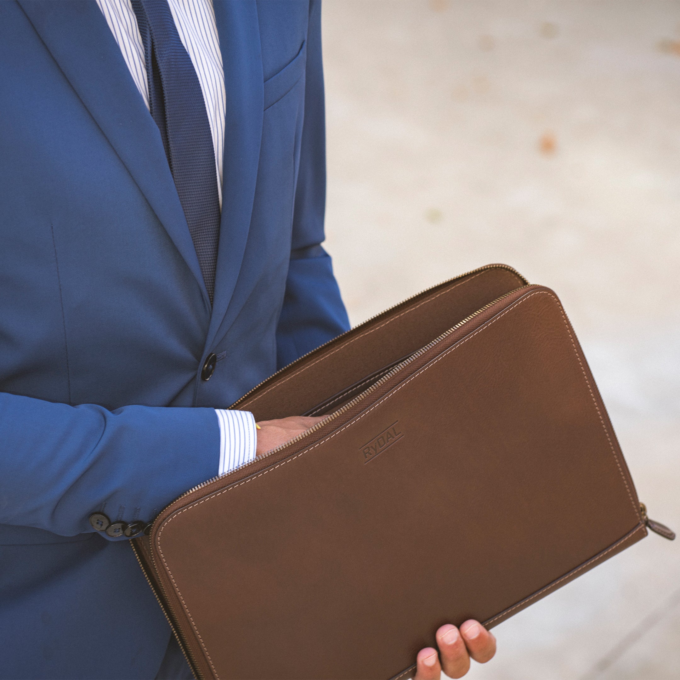 Model carrying Albany Leather Document Holder from Rydal in 'Dark Brown'.